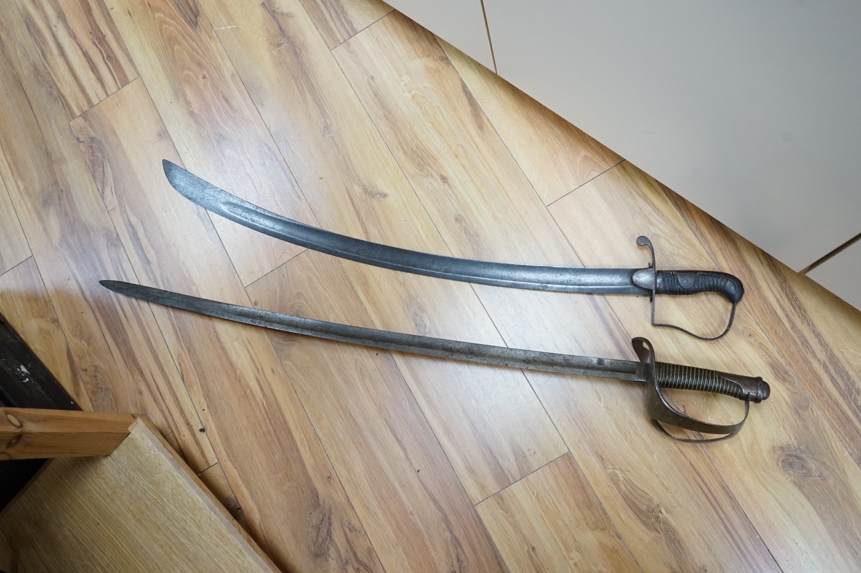 Two swords; a 1796 pattern cavalry troopers regulation pattern sword, the blade stamped W. Deakin, with government inspector’s mark, and regulation hilt, in fair condition, well worn with some light pitting, together wit